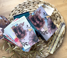 Load image into Gallery viewer, Radiant Crystal cards 2nd edition open box with cards set face up lying on a wicker mat