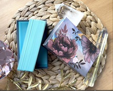 Load image into Gallery viewer, Radiant Crystal Cards 2nd edition open box with cards displayed on their edge lying on a wicker mat