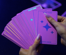 Load image into Gallery viewer, Exotic Cancer Tarot hands holding a fanned out selection of face down cards