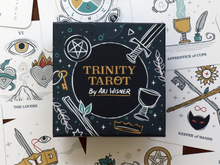 Load image into Gallery viewer, Trinity Tarot box sitting on top of a selection of tarot cards