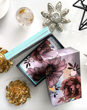 Load image into Gallery viewer, Radiant Crystal cards 2nd edition open box with a selection of cards laying on their side next to the box on a white background
