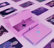 Load image into Gallery viewer, Exotic Cancer Tarot partially open box showing some cards. There is a stack of face down cards next to the box and the background is a grid formation of face up cards
