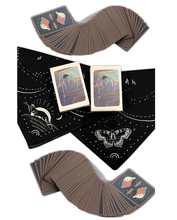 Load image into Gallery viewer, Gentle Tarot linen edition two sets of cards spread in waves face down surrounding 2 closed boxes which are laying on a black altar cloth
