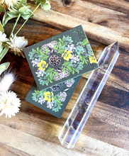 Load image into Gallery viewer, Terra Lenormand closed tuck box sitting on top of stacked deck of cards and lying next to a crystal on a wood background
