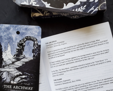 Load image into Gallery viewer, The Archway card laying alongside the guidebook open to the card&#39;s description
