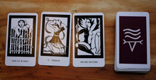 Load image into Gallery viewer, Thea&#39;s tarot cards three cards lying face up in a row next to the rest of the stacked deck lying face down
